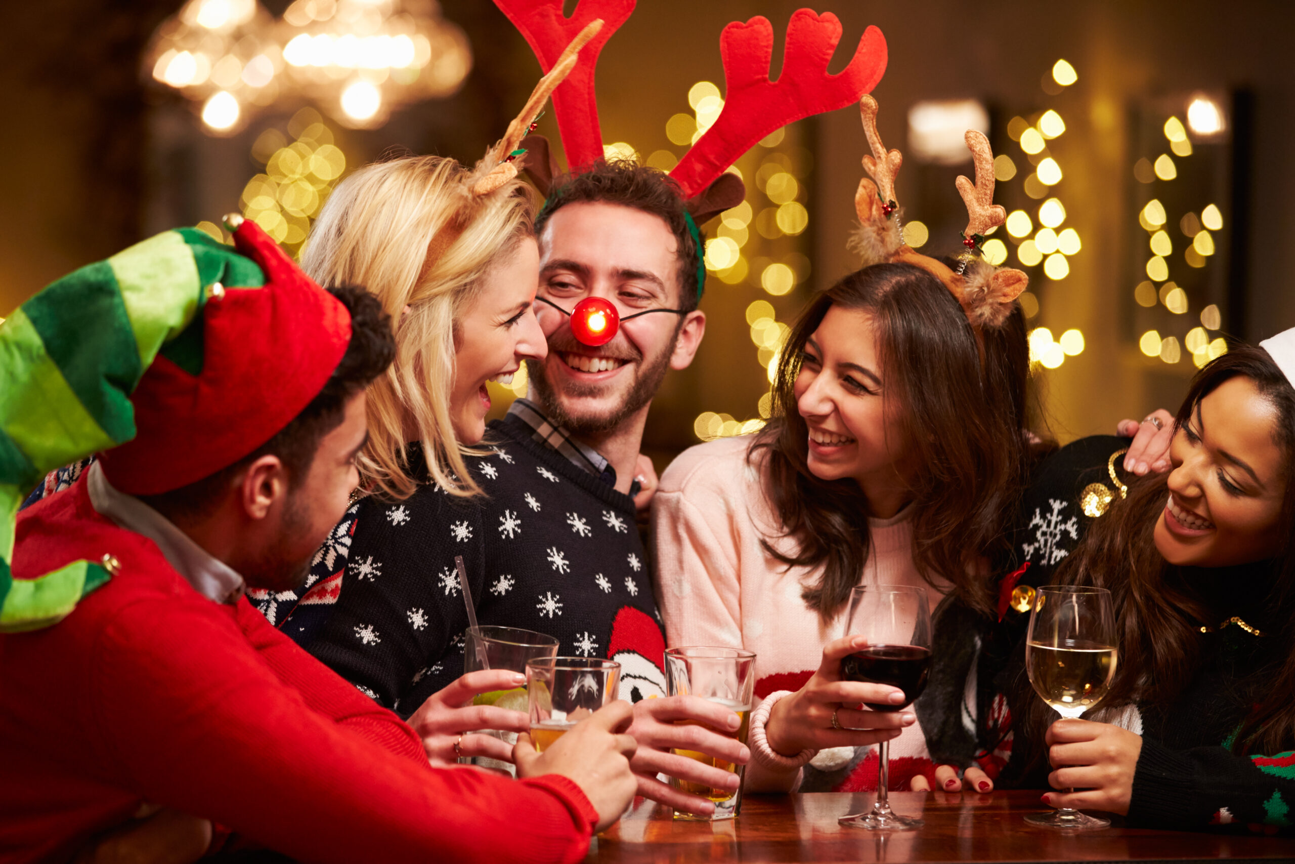 A group of friends dressed up, drinking, and celebrating the holidays at Bertucci's