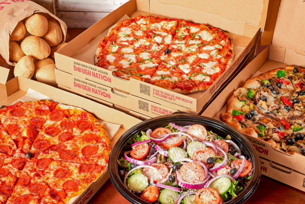 Bertucci's catering package with pizzas, salad, and rolls