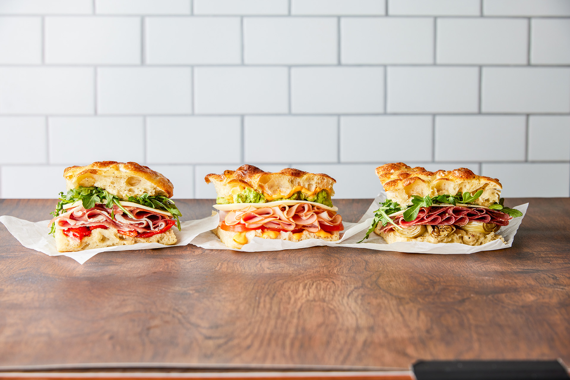 Three sandwiches from Pronto on a counter