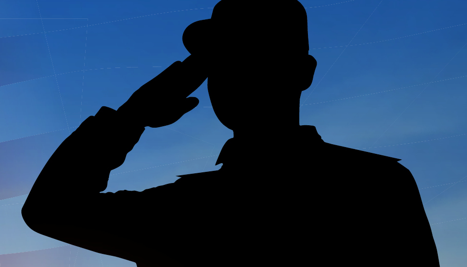 A silhouette saluting the American flag