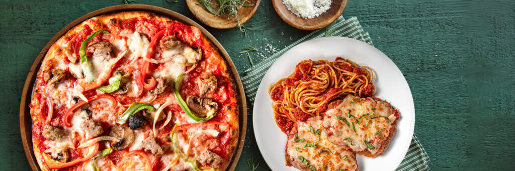 A Bertucci's pizza and chicken parm on a green tablecloth