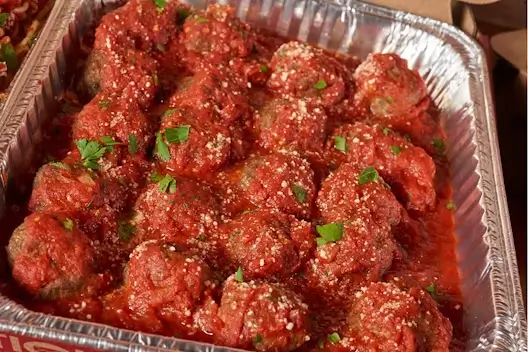 A catering tray of freshly prepared hand-crafted meatballs