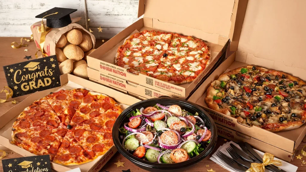 Bertucci's catering pizzas with graduation signs and graduation caps