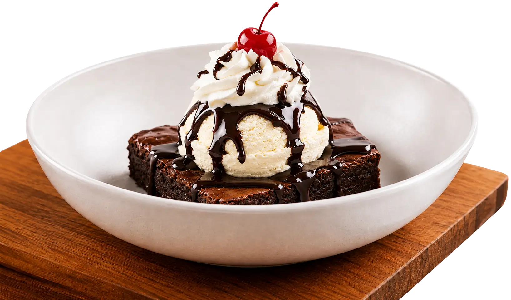 A large white bowl of brownie sundae resting on a wooden cutting board