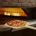 Bertucci's Brick Oven Pizza being taken out of the oven